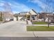 Charming home featuring a three car garage, stone accents, and a well maintained lawn at 5474 Espana St, Denver, CO 80249