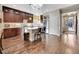 Spacious kitchen featuring granite countertops, dark wood cabinets and hardwood flooring at 5474 Espana St, Denver, CO 80249