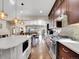 Spacious kitchen featuring granite countertops, dark wood cabinets and hardwood flooring at 5474 Espana St, Denver, CO 80249