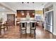Bright kitchen features a spacious island with seating, stainless steel appliances, and dark wood cabinetry at 5474 Espana St, Denver, CO 80249