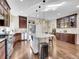 Bright kitchen with granite countertops, an island with bar stool seating, and hardwood flooring at 5474 Espana St, Denver, CO 80249
