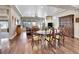 Open-concept living room features dining room with hardwood floors and view to the yard at 5474 Espana St, Denver, CO 80249