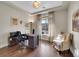 Bright home office with a large window, wood floors and a comfortable seating area at 5474 Espana St, Denver, CO 80249
