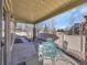 Covered patio with an outdoor dining set and a view of the backyard at 5474 Espana St, Denver, CO 80249
