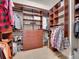 Organized walk-in closet featuring custom shelving, drawers, and ample hanging space for clothing storage at 5474 Espana St, Denver, CO 80249