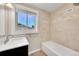 Neutral bathroom with a shower-tub combination, mosaic tile accents, and a vanity sink at 4268 S Delaware St, Englewood, CO 80110