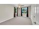 Empty bedroom features plush carpeting, two windows with dark curtains, and a ceiling fan at 4268 S Delaware St, Englewood, CO 80110