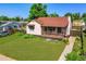 Charming brick home featuring a well-manicured lawn and a cozy, covered front porch at 4268 S Delaware St, Englewood, CO 80110