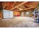 Spacious garage with exposed wooden ceiling, offering ample storage and parking space at 4268 S Delaware St, Englewood, CO 80110