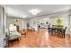 Open-concept living room and dining area featuring gleaming hardwood floors and ample natural light at 4268 S Delaware St, Englewood, CO 80110