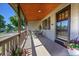 Inviting covered front porch featuring neutral brickwork and a seating area at 4268 S Delaware St, Englewood, CO 80110