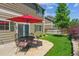 Spacious backyard with a patio, outdoor seating, well-maintained lawn, and privacy fence at 7342 S Mobile St, Aurora, CO 80016