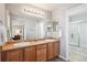 Spacious bathroom with a double sink vanity, large mirror, and walk-in shower at 7342 S Mobile St, Aurora, CO 80016
