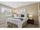 A charming bedroom with a comfortable bed, dresser, and large sunny window at 7342 S Mobile St, Aurora, CO 80016