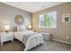 Well-lit bedroom with a large window, two side tables, and a simple bed at 7342 S Mobile St, Aurora, CO 80016