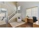 Bright entryway features a staircase, wood floors, and a cozy sitting area with desk at 7342 S Mobile St, Aurora, CO 80016