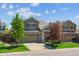 Charming two-story home with a brick facade, attached garage, and landscaped front yard at 7342 S Mobile St, Aurora, CO 80016