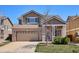 Beautiful two-story home boasts a two-car garage, brick accents, and a well-maintained front yard at 7342 S Mobile St, Aurora, CO 80016
