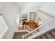 Aerial view of a home office with large desk and stairs leading to the entry way at 7342 S Mobile St, Aurora, CO 80016