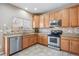 Well-appointed kitchen features stainless steel appliances and ample counter space at 7342 S Mobile St, Aurora, CO 80016