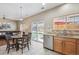 Bright kitchen with stainless steel appliances and view to backyard patio at 7342 S Mobile St, Aurora, CO 80016