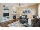 Inviting living room featuring a fireplace, built-in shelving, and stylish, comfortable, leather furniture at 7342 S Mobile St, Aurora, CO 80016