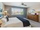 Comfortable main bedroom with a ceiling fan and large window with neighborhood views at 7342 S Mobile St, Aurora, CO 80016