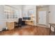 Bright office featuring a large desk, dual monitors, hardwood floors, and natural light at 7342 S Mobile St, Aurora, CO 80016