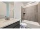 Modern bathroom features a shower-over-tub with tiled surround and updated vanity with undermount sink at 630 Sunrise St, Erie, CO 80516