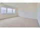 Carpeted bedroom with large windows, neutral walls, and ample natural light at 630 Sunrise St, Erie, CO 80516