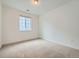 Cozy carpeted bedroom featuring bright, neutral walls, and ample natural light at 630 Sunrise St, Erie, CO 80516