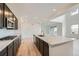 Modern kitchen with stainless steel appliances, dark wood cabinets, and large island with quartz countertop at 630 Sunrise St, Erie, CO 80516
