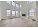 Spacious living room with high ceilings, large windows, contemporary fireplace, and light hardwood floors at 630 Sunrise St, Erie, CO 80516