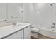 Modern bathroom featuring a tub, stylish flooring, and a granite vanity at 240 Lark Sparrow Way, Bennett, CO 80102