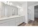 Double vanity bathroom featuring a glass shower and modern lighting fixtures at 240 Lark Sparrow Way, Bennett, CO 80102