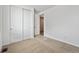Bright bedroom with plush carpeting and closet and ensuite bathroom access at 240 Lark Sparrow Way, Bennett, CO 80102