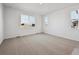Large, bright bedroom featuring neutral carpeting and multiple windows at 240 Lark Sparrow Way, Bennett, CO 80102