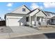 Well-maintained single-Gathering home featuring a welcoming front porch and a two-car garage, ideal for modern living at 240 Lark Sparrow Way, Bennett, CO 80102