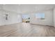 Bright and open living room with lots of natural light highlighting the wood-look flooring and modern design at 240 Lark Sparrow Way, Bennett, CO 80102