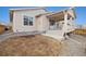 Backyard featuring a porch area, steps leading to the yard, and partial fencing, offering a partially landscaped space at 16249 Lanceleaf Pl, Parker, CO 80134