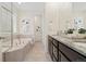 Bathroom showcasing a soaking tub, tile floors, and a double vanity at 16249 Lanceleaf Pl, Parker, CO 80134