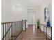 Hallway features hardwood floors and neutral decor, leading to the home's entrance at 16249 Lanceleaf Pl, Parker, CO 80134