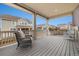 Covered porch with comfortable wicker furniture, offering a relaxing outdoor space overlooking the backyard at 16249 Lanceleaf Pl, Parker, CO 80134