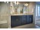 Well-lit bathroom featuring double vanity, sleek cabinets, gold fixtures, and a modern glass shower at 39210 Anthony St, Elizabeth, CO 80107