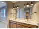 Bathroom features a double sink vanity, sleek fixtures, a large mirror and contemporary lighting at 39210 Anthony St, Elizabeth, CO 80107