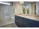 Beautiful bathroom with dual sinks, navy cabinets, gold fixtures, and a glass-enclosed shower at 39210 Anthony St, Elizabeth, CO 80107