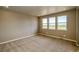 Bedroom with neutral carpet and three large windows overlooking the neighborhood at 39210 Anthony St, Elizabeth, CO 80107