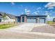 Attractive single-story home with three-car garage, rock details, and wide driveway at 39210 Anthony St, Elizabeth, CO 80107