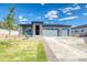 Charming single-story home with a three-car garage, stone accents, and a well-manicured lawn at 39210 Anthony St, Elizabeth, CO 80107