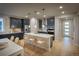 Bright kitchen with stainless steel appliances, large island, pendant lighting, and modern finishes at 39210 Anthony St, Elizabeth, CO 80107